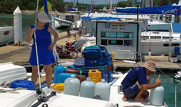 Gail helps Jon siphon water into our starboard tank