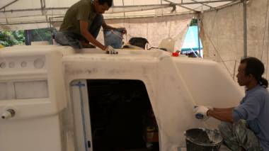 Baw and Lek wet-sanding the front of the cockpit