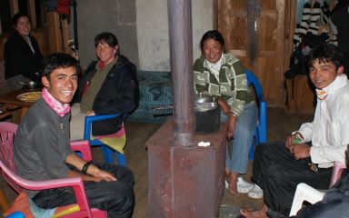 Amanda, Sonia, & our porters around the lodge fireplace