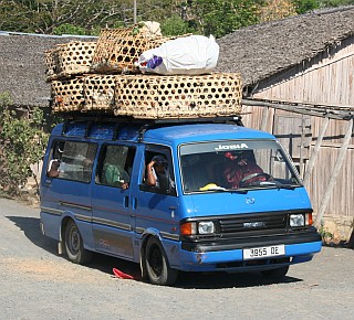 A well-laden taxi-brousse with chickens on top