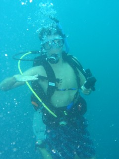 Chris signals to level out during a safety stop above the wreck.