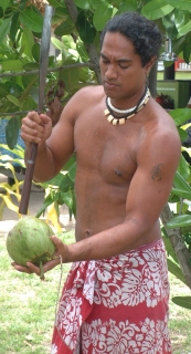 Ringa, a native of Polynesian Rotuma (Fiji) whacks open a green drinking nut.
