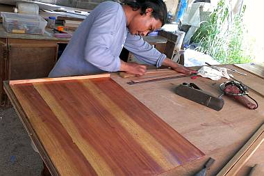 Houa working on one of our "Galapagos teak" shelves