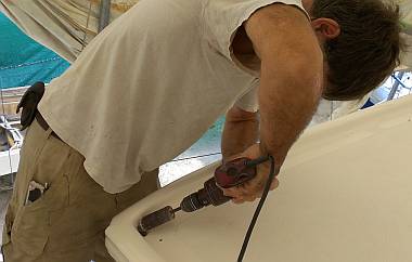 Opening up the water-catch hole to the starboard bimini leg