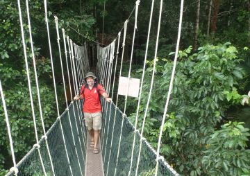 Jon balances on the canopy walk, Taman Negara