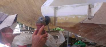 Jon grinding the old filler off the back of the port transom