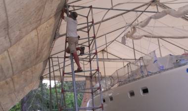 Jon, high in the air, replacing the guy ropes for our tent & awning