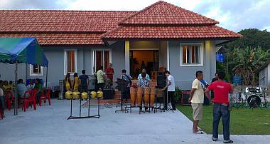 The band setting up in front of Manoon's new house