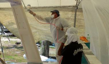 Mike re-spraying the targa-bar behind plastic masking