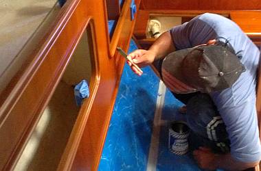 Pla touching up the satin varnish in the port aft cabin