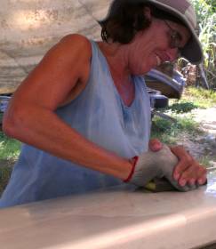Sue wet-sanding the mast with 320 grit