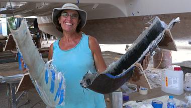 Sue holds the 2 bow molds, port with carbon, starboard without