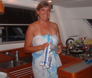 Sue doing dishes in her compact galley