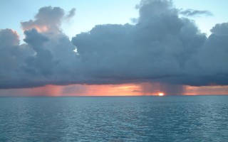 Sunset with a squall and Trade Wind clouds, off Raiatea.