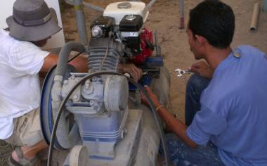 Jon and Baw reassembling the motor on our compressor